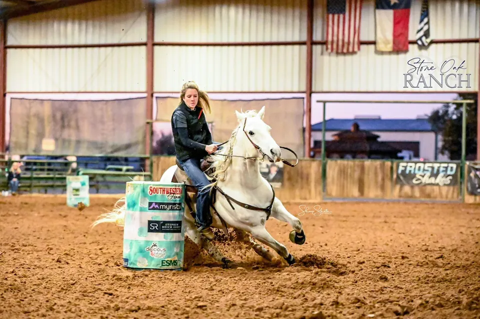 Barrel horse turning the barrel in a Texas arena