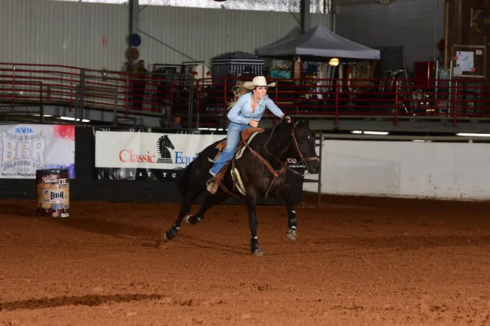 Lexi Rankin riding a bay barrel horse